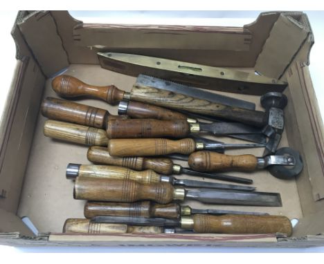 A collection of vintage chisels and other tools.