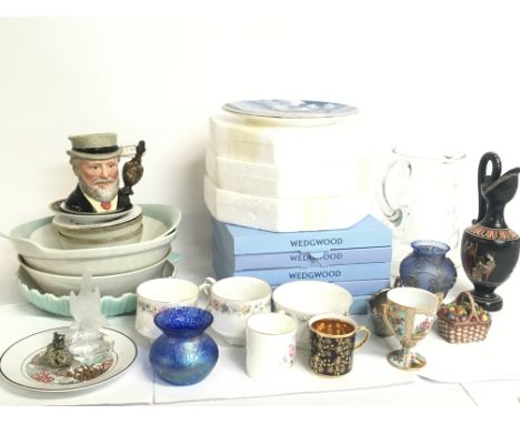 An assortment of ceramics including boxed Wedgewood limited Edition plates, Royal Albert cups, Wedgewood bowl, Poole dishes e