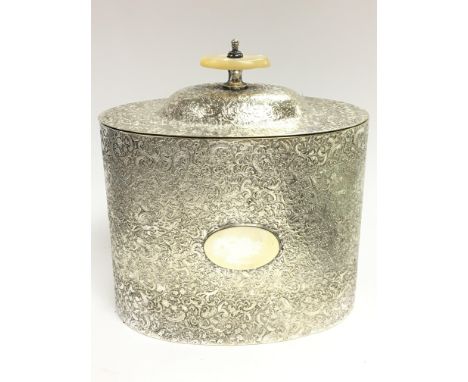 An unusual silver plated tea caddy with raised decoration and mother of pearl handle, approximately 14cm tall. postage catego