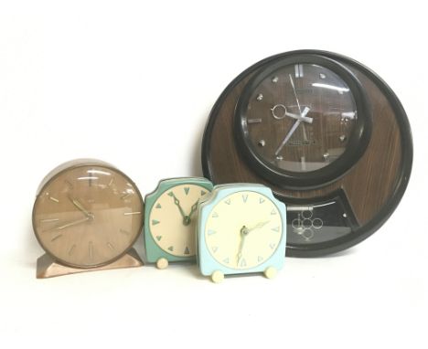 Vintage clocks including a Coramatic Transistor wall clock, a Smiths mantel clock and two APL clocks