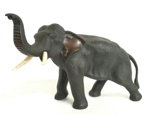 A Meiji period Japanese bronze elephant figure with bone tusks, 18cm tall. Postage category C