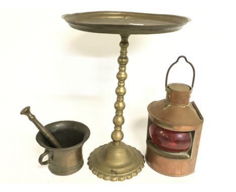 A brass pestle and mortar, copper port bow light, brass pedestal (44cm tall)