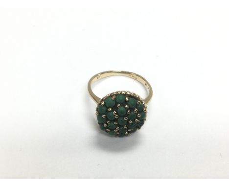 A gold ring set with green stones, approx 3g and approx size J-K. Shipping category A.- NO RESERVE
