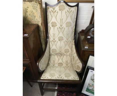 An oak wood Edwardian chair with light beige floral design upholstery. 130cm tall.