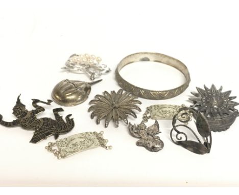 A collection of silver jewellery including brooches and a bangle. 100g in total. postage category A- NO RESERVE