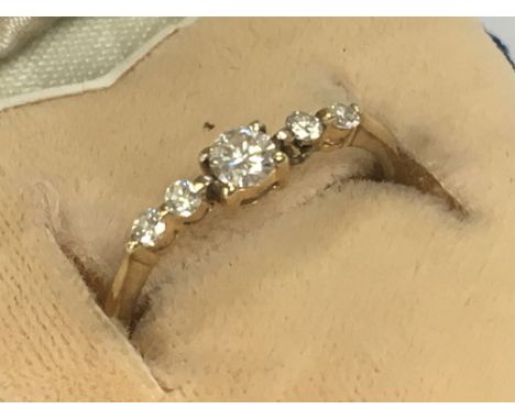 An 18ct yellow gold ring inset with a row of five small diamonds