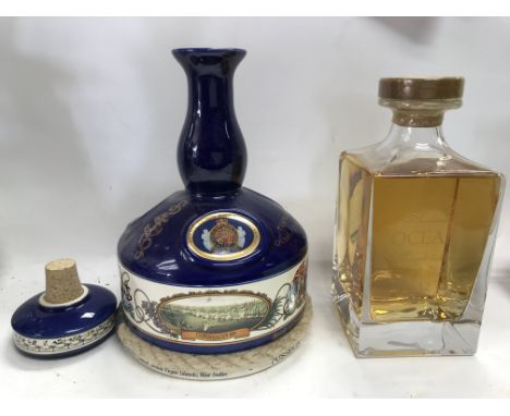 A ceramic bottle of rum and a oceana 12 year aged bottle of single malt whiskey.