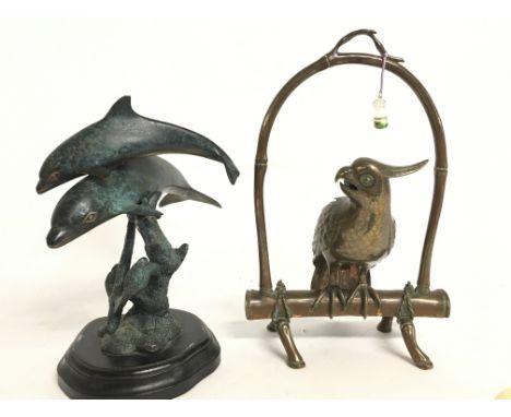 A copper parrot figure and a bronze dolphin figure group. Postage catC