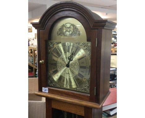 A Mahogany longcase clock with a brass dial and visible brass weights.