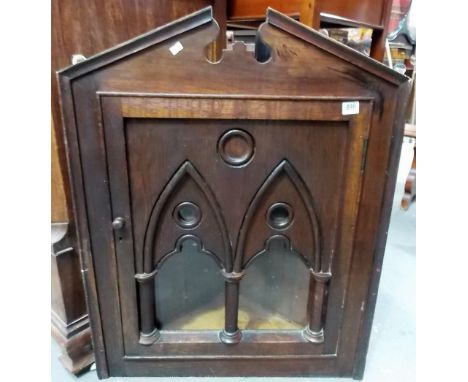 Early 20th Century oak Arts & Crafts gothic style wall hanging corner cupboard, the hinged door with two architectural arch g