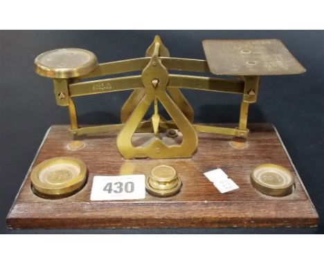 Set of brass postal scales with four stacking weights.