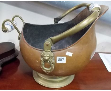 Victorian copper and brass coal helmet with blue and white ceramic handles