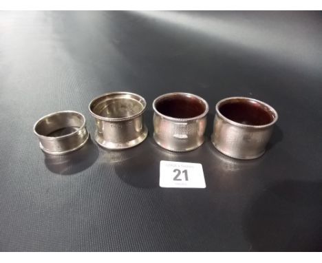Pair of silver engine turned and Bakelite napkin rings together with two other napkin rings