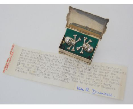 A pair of skull &amp; cross bones cufflinks or shirt studs in a silver plated box. Purported to be of local interest regardin