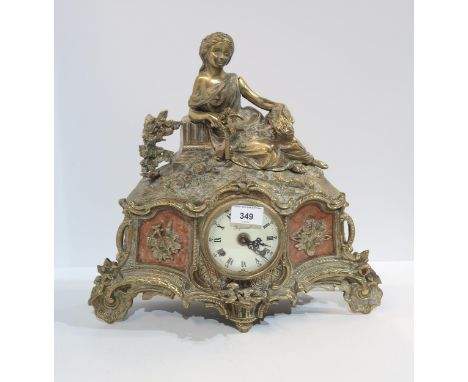 An Imperial mantle clock, with brass mounts and figural top, inset with red marble panels Condition Report:Available upon req