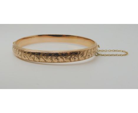 A 9ct gold leaf engraved hollow bangle, hallmarked Birmingham 1918 inner diameter 6.2cm, width 8mm, weight 8.6gms Condition R