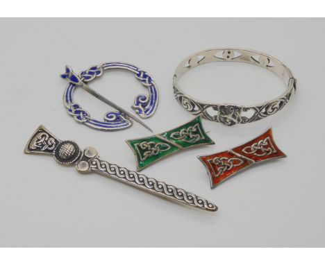 A Scottish silver bangle by Robert Allison, together with three enamelled brooches by Iain Mac Cormick and a silver sword sha