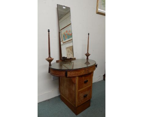 An early 20th century oval topped dressing table with narrow mirror flanked by lamp/candle sconces above two over two drawers