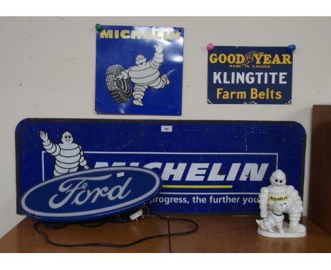 AUTOMOBILIA A cast iron advertising Michelin figure, two Michelin advertising signs, a Goodyear advertising sign and a Ford i