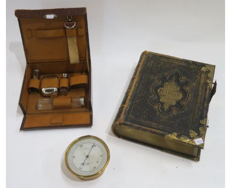 A military compensated barometer by Short &amp; Mason Ltd., London, a family bible and a gentleman's travelling toiletry set 