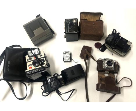 A selection of vintage cameras, to include Polaroid and Paxette