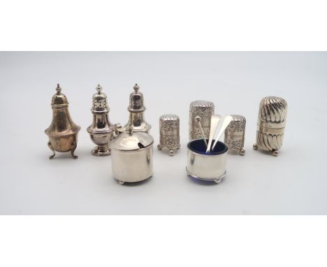 A set of three silver casters, the bodies with chased floral decoration, by Haseler Brothers, London 1892, a pair of baluster