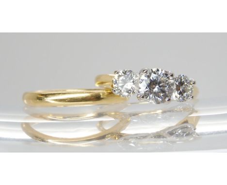 An 18ct gold three stone diamond ring set with estimated approx 1.20cts in total, in a pretty leaf design mount, finger size 