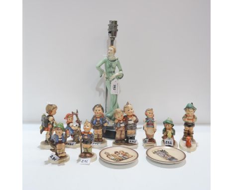 A continental pottery Art Deco style lady together with nine Hummel figures and two dishes Condition Report:Available upon re