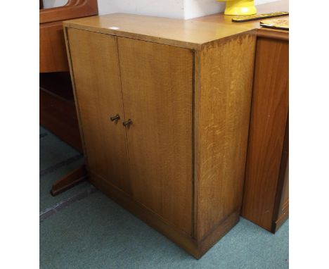 A 20th century two door cabinet, nest of three tables, magazine rack and Lloyd loom style hamper (4) Condition Report:Availab