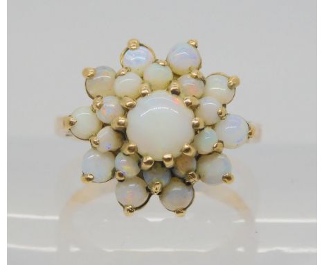A 9ct gold opal cluster ring, size K, weight 4.3gms Condition Report:One of the smallest opals has a chip