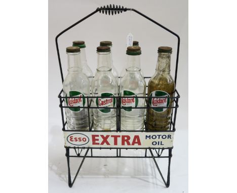 AUTOMOBILIA An Esso Extra Motor Oil advertising stand/bottle carrier, with seven Castrol Motor Oil glass bottles Condition Re