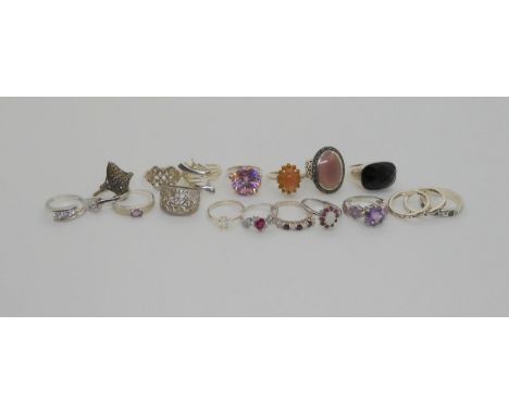 A collection of silver gem set rings to include ruby and opal cluster, a First Nation South Western Bear's paw 3 x staker rin