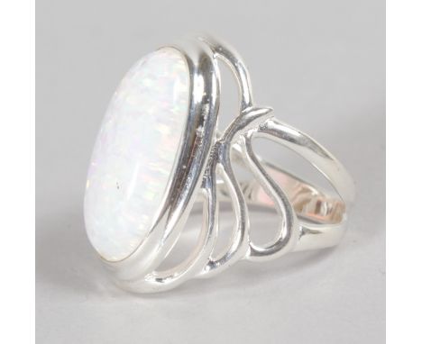 AN ART NOUVEAU SILVER GILSON OPAL DRESS RING.