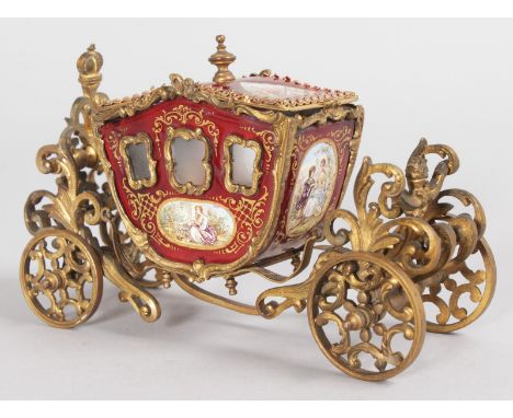 A SUPERB SMALL VIENNA GILT AND ENAMEL CEREMONIAL COACH with painted panels of young children. 5.5ins long.