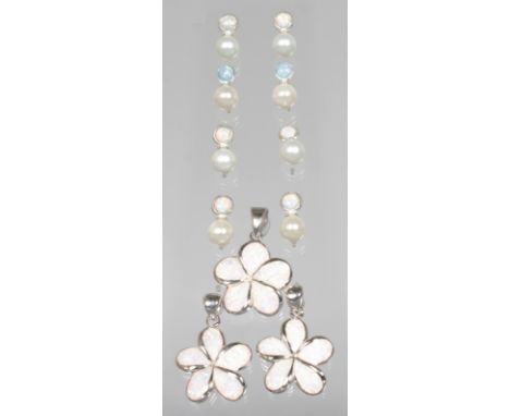 THREE SILVER AND OPAL CLOVER LEAF PENDANTS and four pairs of earrings.