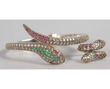 A SILVER AND SILVER GILT SNAKE RUBY SET BANGLE AND RING.
