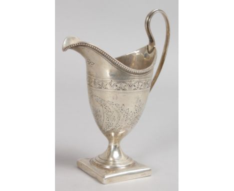 A GEORGE III BRIGHT CUT HELMET SHAPED CREAM JUG. London 1792.  Maker: George Coles.
