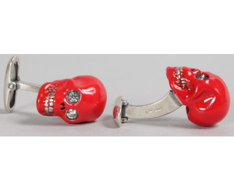 A PAIR OF RED ENAMEL AND SILVER SKULL CUFFLINKS.