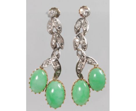 A PAIR OF WHITE GOLD, DIAMOND AND JADE EARRINGS, with leaf shape supports inset with small diamonds and a pair of cabochon ja