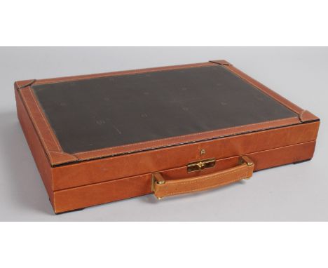 A LEATHER BOUND BACKGAMMON CASE.