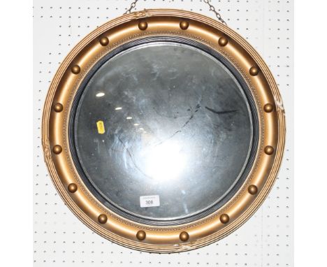 A Regency design convex wall mirror in ball decorated gilt frame and a Rococo design firescreen inset floral print