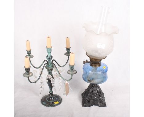 A Victorian oil lamp with moulded glass shade, blue glass reservoir and cast metal base, another brass oil lamp, a hanging oi