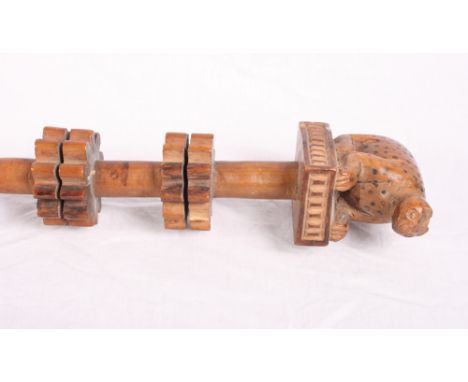 An African walking stick carved leopard grip and two twin cog wheels to stem