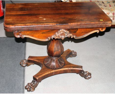 A William IV period rosewood fold-over top card table with circular red baize playing surface, on octagonal baluster column a