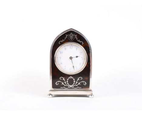 A silver and tortoiseshell arch top bracket clock by William Comyns with silver pique decoration, retailed by Mappin & Webb, 