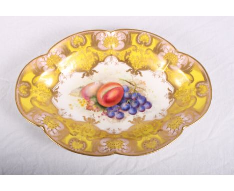 A Royal Worcester oval cabinet dish decorated yellow, pink and gilt border, centre painted fruit, signed E Phillips, 11" long