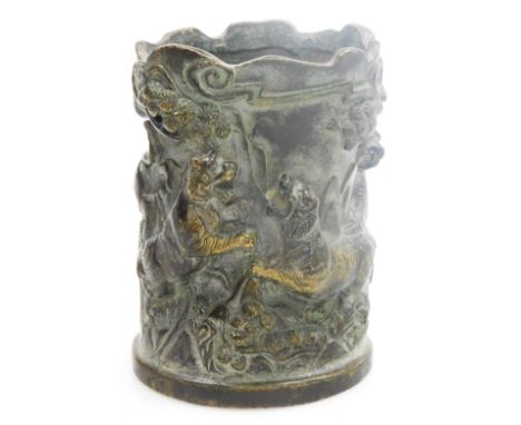 A Chinese bronze brush pot, relief decorated with tigers in a jungle, circular four character Qianlong mark, 12.5cm high.