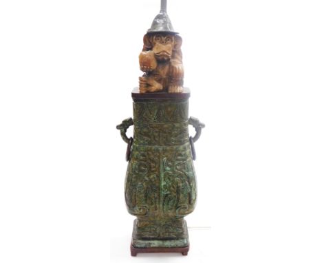 A Chinese bronze vase, of archaic style twin handle, baluster form, later converted to a table lamp, surmounted with a carved