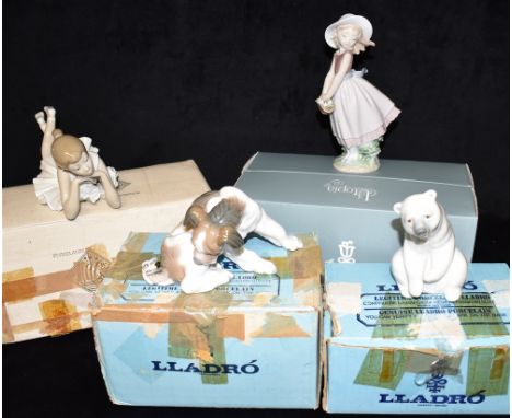 THREE BOXED LLADRO FIGURES AND ONE BOXED NAO FIGURE:  model 1208 resting Polar Bear, model 917 Surprised Puppy, model 0100824