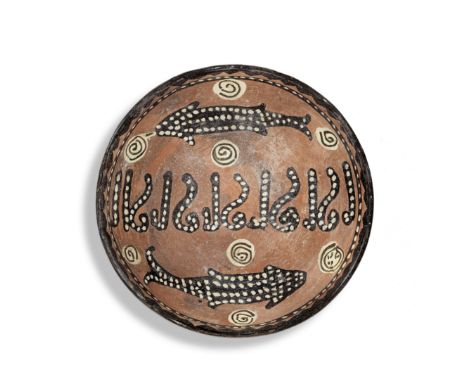 A Nishapur slip-painted pottery bowl Persia, 10th Centuryof rounded form on a short foot, decorated in manganese, cream and t